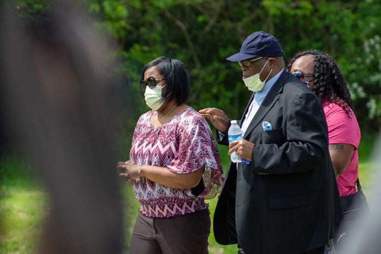 Dreasjon Reed's mother, Demtree Wynn, walks with Elder Lionel Rush of Greater Anointing Fellowship Church before a press conference June 2 near Michigan Road and 62nd Street